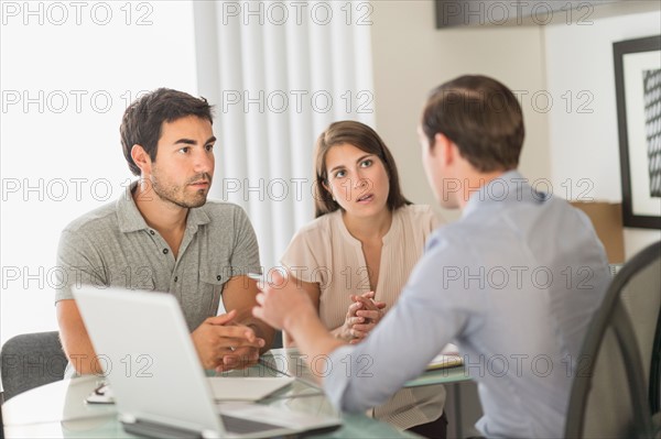 Customers talking to advisor in office.