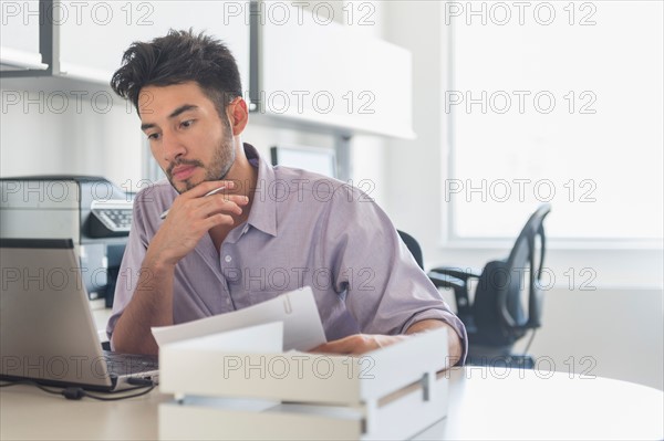 Businessman at work in office.