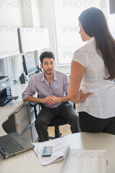 Business man and woman at work in office.