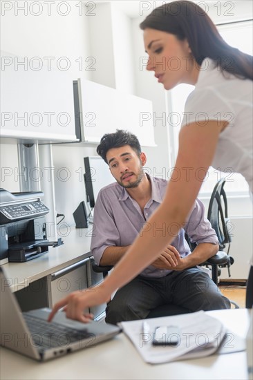 Business man and woman at work in office.