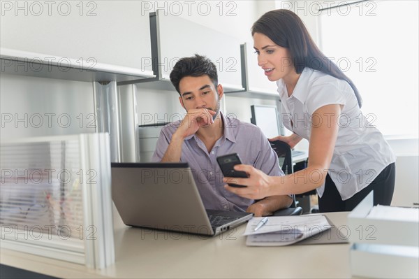 Business man and woman at work in office.