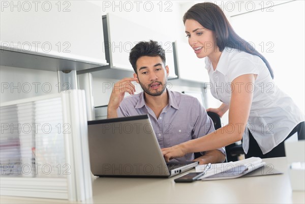 Business man and woman at work in office.