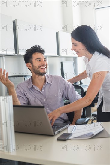 Business man and woman at work in office.