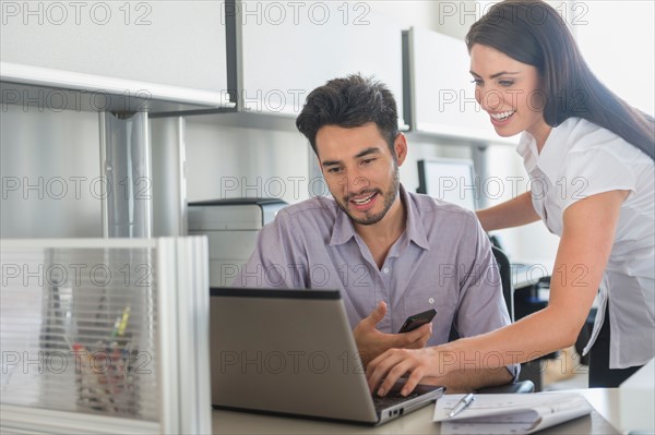 Business man and woman at work in office.