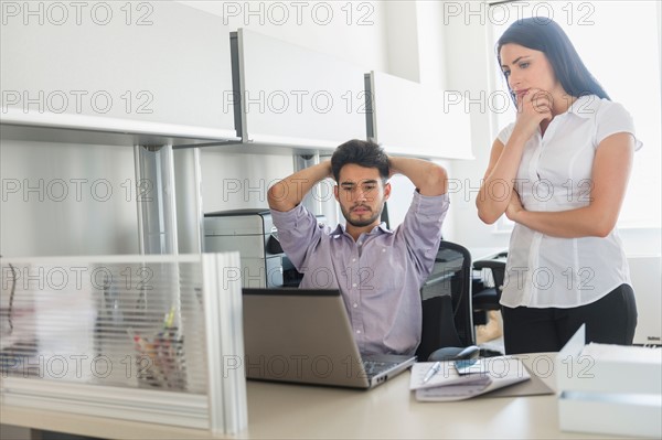 Business man and woman at work in office.