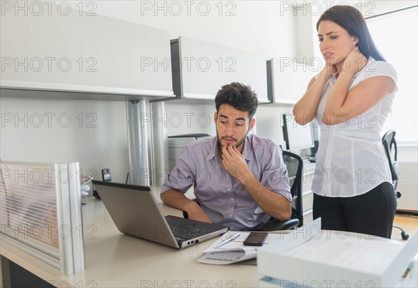 Business man and woman at work in office.