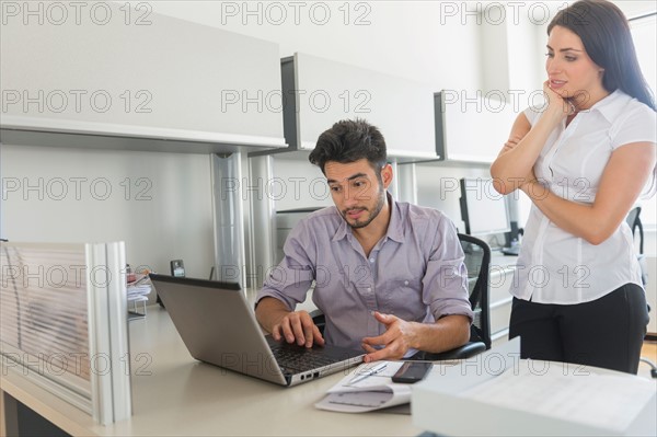 Business man and woman at work in office.