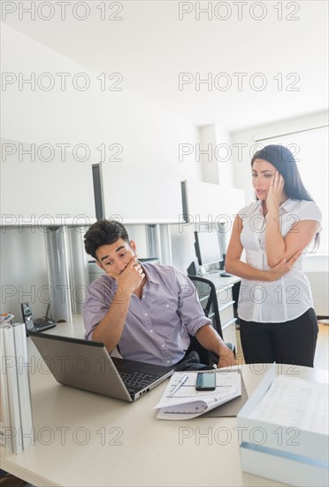 Business man and woman at work in office.