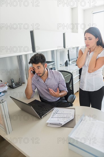 Business man and woman at work in office.