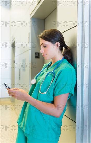 Female doctor text messaging.