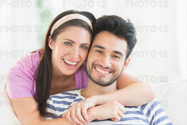 Portrait of young couple smiling.