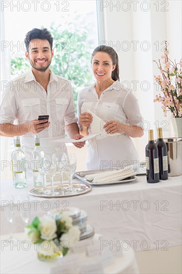 Business owners preparing dining table.