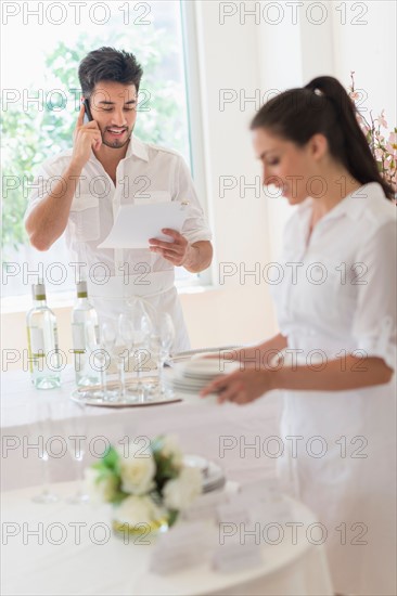 Business owners preparing dining table.