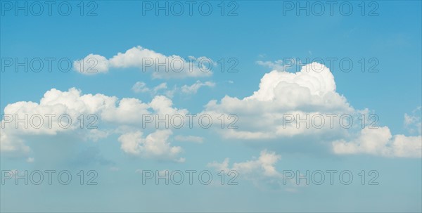 Puffy clouds on blue sky.