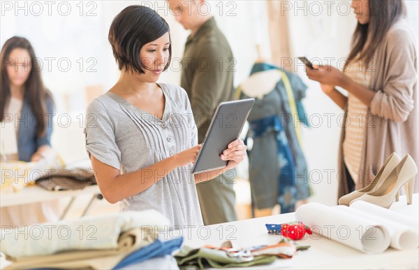 Young fashion designers working in studio.