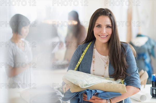 Portrait of young fashion designer in studio.