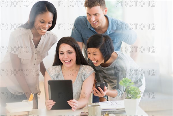 Group of young friends using digital tablet.