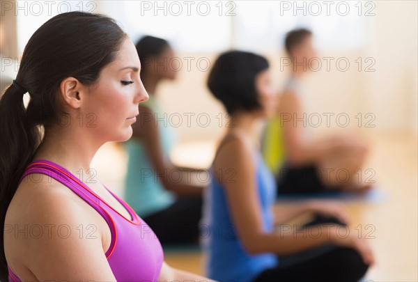 People training yoga in gym.