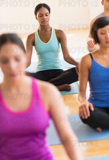 People training yoga in gym.