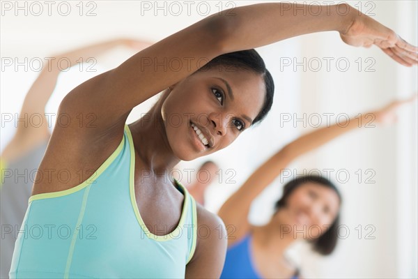 People stretching in gym.