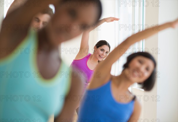 People stretching in gym.