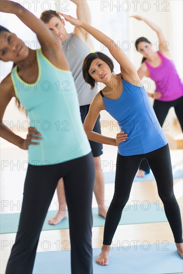 People stretching in gym.