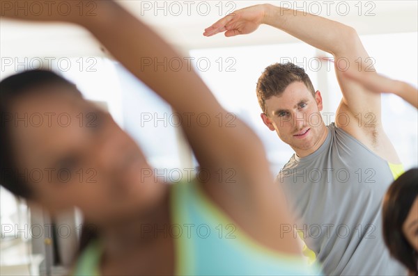 People stretching in gym.