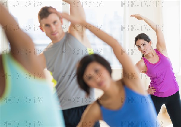 People stretching in gym.