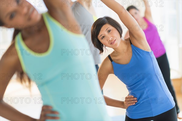 People stretching in gym.