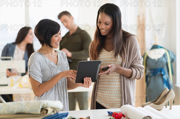 People working in fashion studio.