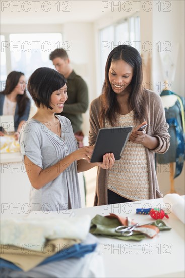 People working in fashion studio.