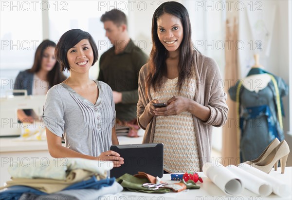 People working in fashion studio.