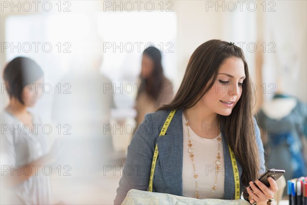 People working in fashion studio.