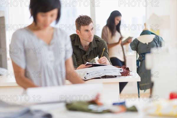 People working in fashion studio.