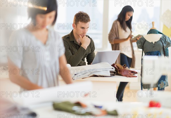 People working in fashion studio.