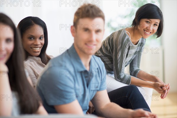 Friends sitting on sofa.