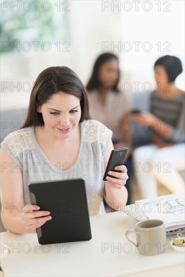 Woman using digital tablet and mobile phone.