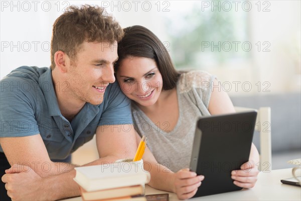 Couple using digital tablet.