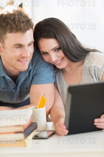 Couple using digital tablet.