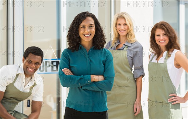 Portrait of smiling business owner with her workers.