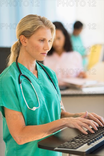 Doctor working at desks in hospital.