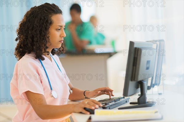 Doctor working at desks in hospital.