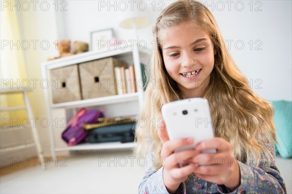 Girl (8-9) using mobile phone