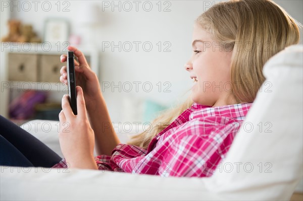 Girl (8-9) reading e-reader