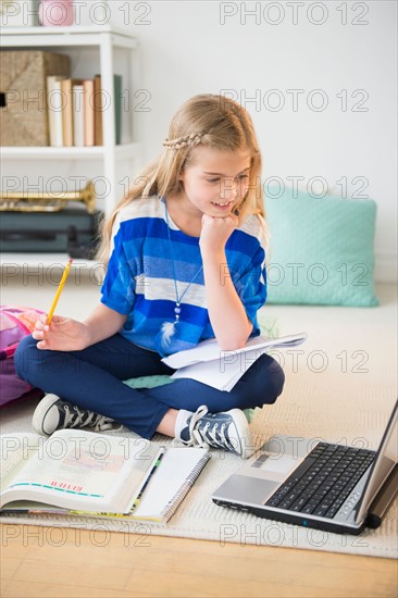 Girl (8-9) doing homework