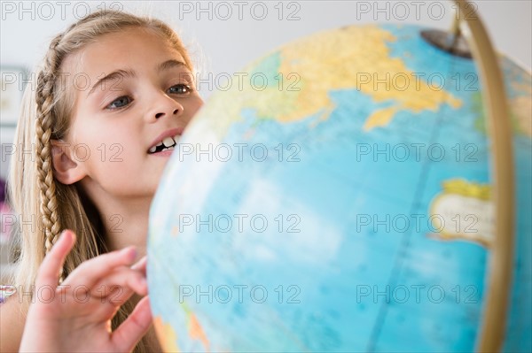 View of girl (8-9) with globe