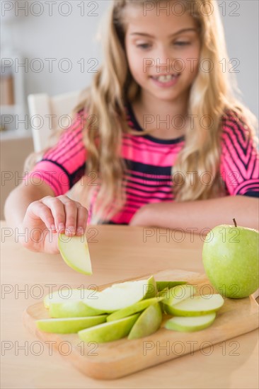 Portrait of girl (8-9) eating apple