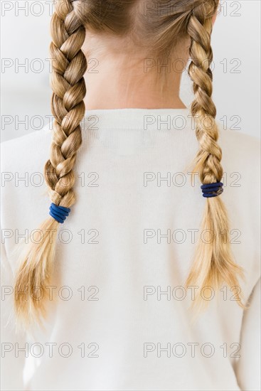 Rear view of girl (8-9) with plaits