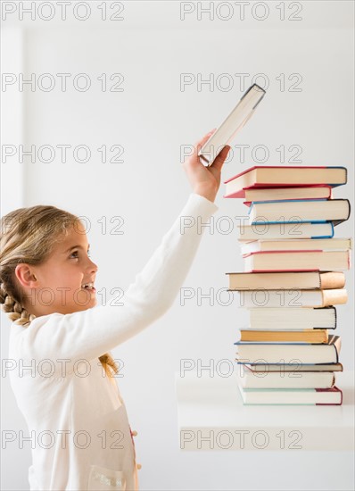 Portrait of girl (8-9) holding book