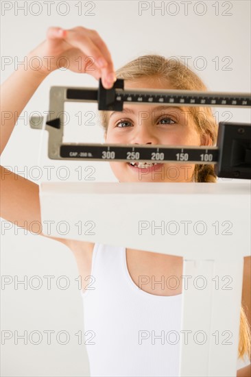 View of girl (8-9) with weight scale